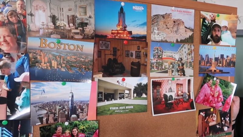 Image of A Bulletin Board Adorned with Various Postcards and Photographs from Places Like Boston, the Kennedy Space Center, and The Statue of Liberty, Mixed with Family Photos