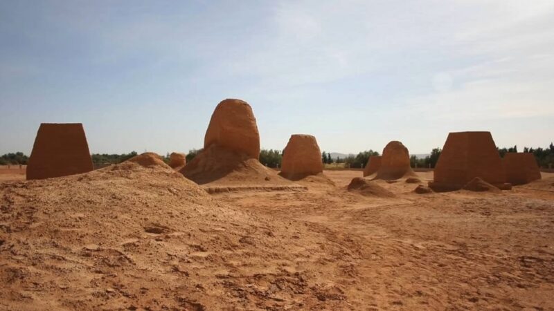 Ancient burial mounds and ruins in the Western Sahara under clear sky